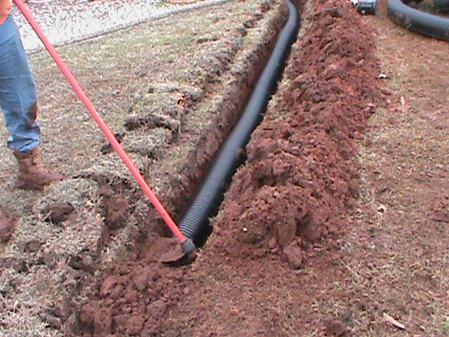 Installing a Drain Pipe For a French Drain that Releases water through a Pop-Up Emitter at the Street