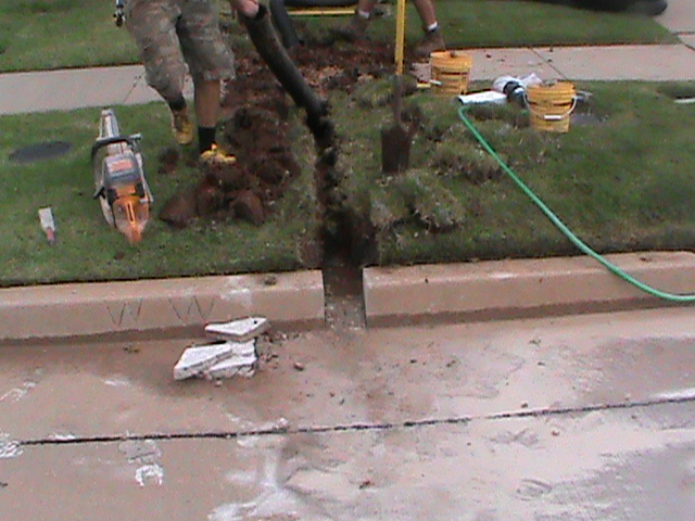 Installing a Curb Outlet for a French Drain in Oklahoma City